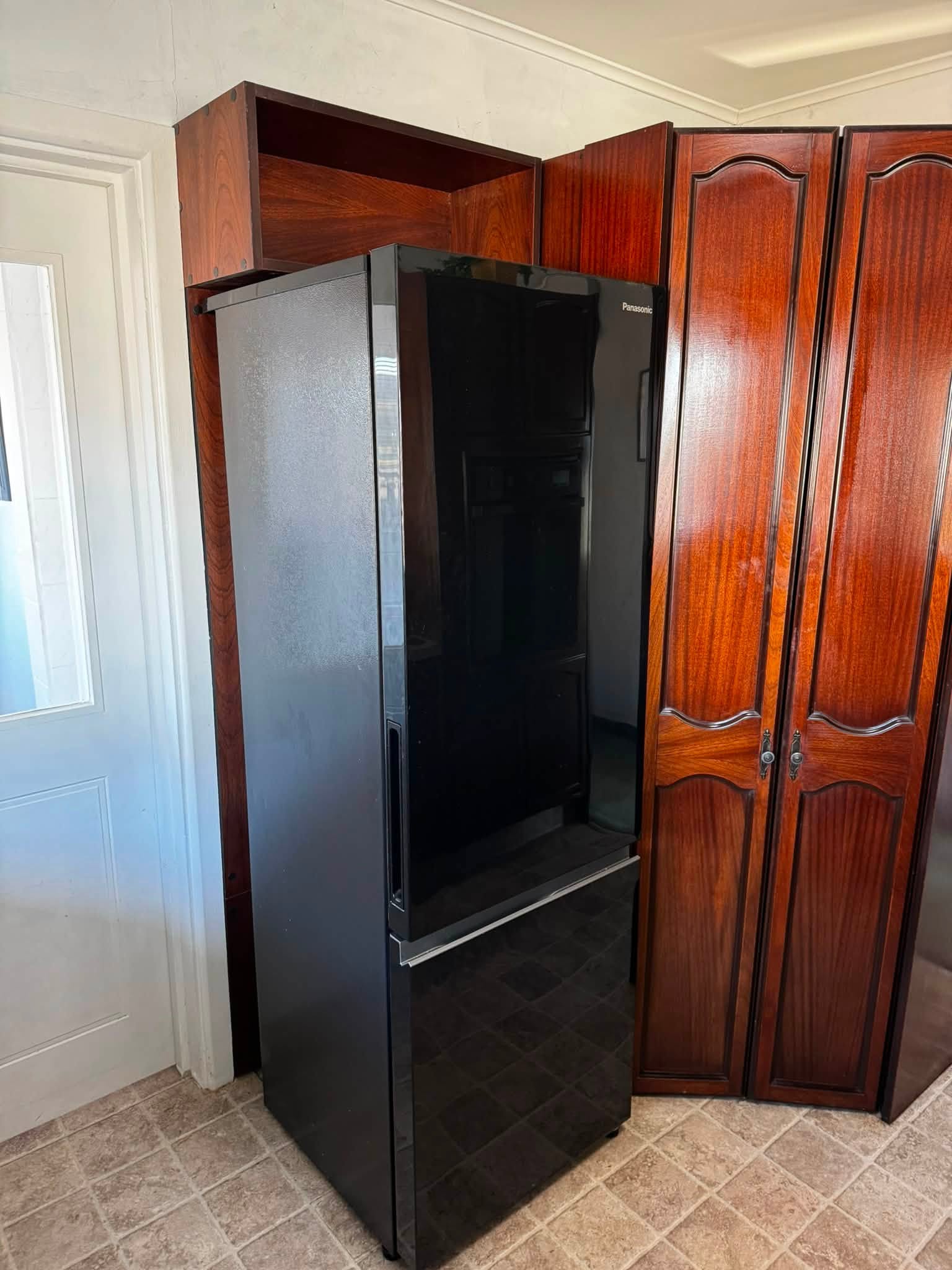Finished custom timber enclosure around a kitchen fridge